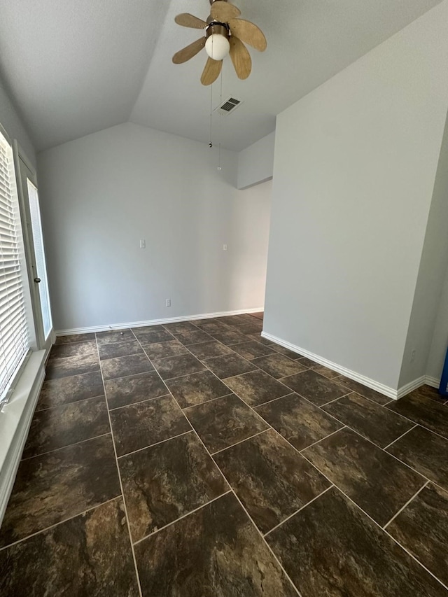 empty room with ceiling fan and vaulted ceiling