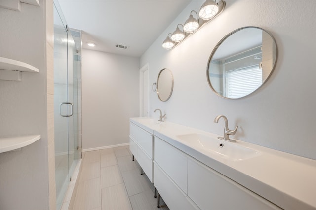 bathroom featuring vanity, walk in shower, and tile patterned flooring