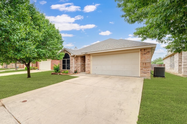 single story home with a front yard, central AC, and a garage