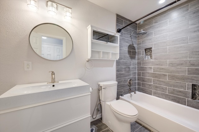 full bathroom with vanity, toilet, and tiled shower / bath combo