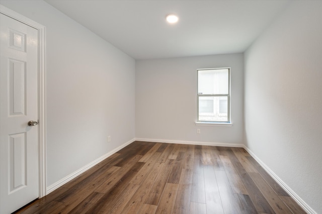 unfurnished room featuring dark wood-type flooring