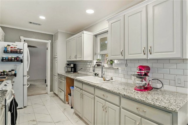 kitchen with stainless steel range with electric stovetop, white cabinetry, sink, and white refrigerator