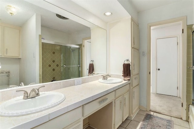 bathroom with vanity, tile patterned floors, and an enclosed shower