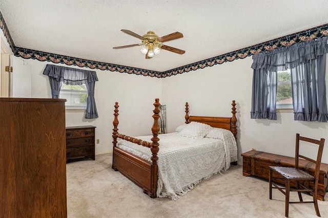 bedroom featuring ceiling fan and light colored carpet