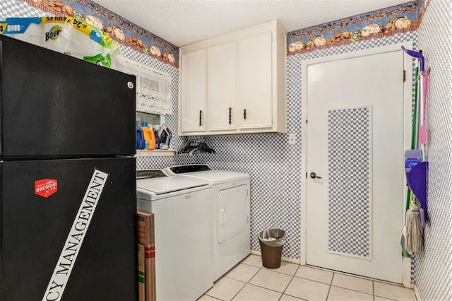 washroom with washer and dryer, cabinets, and light tile patterned floors