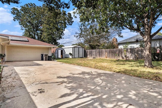 view of side of home with a shed and a yard