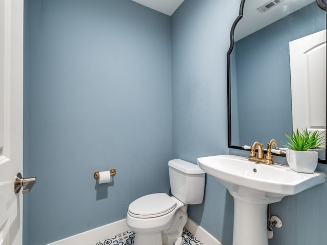 bathroom featuring tile patterned flooring and toilet