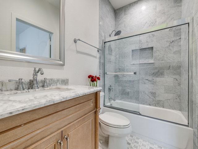 full bathroom with vanity, toilet, and shower / bath combination with glass door