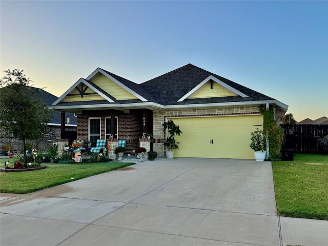 craftsman-style home with a garage and a lawn