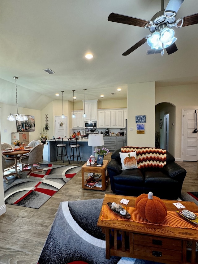 living room featuring light hardwood / wood-style flooring, ceiling fan, and lofted ceiling