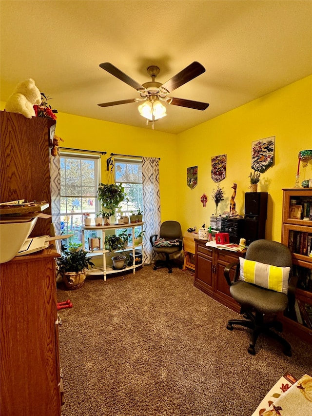 carpeted home office featuring ceiling fan