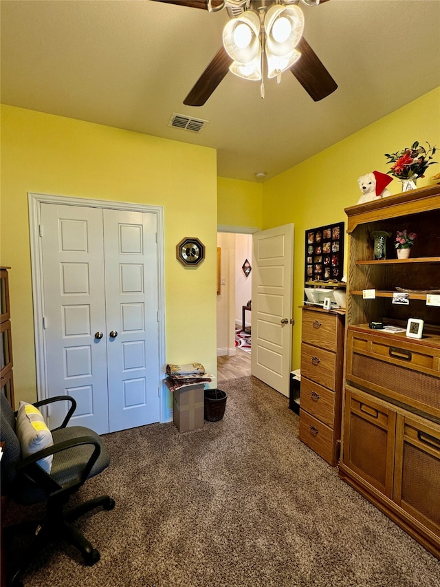 carpeted home office with ceiling fan