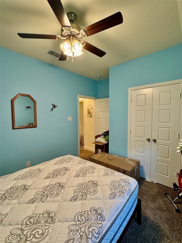 carpeted bedroom featuring a closet and ceiling fan