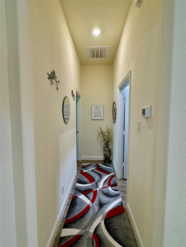 corridor featuring wood-type flooring