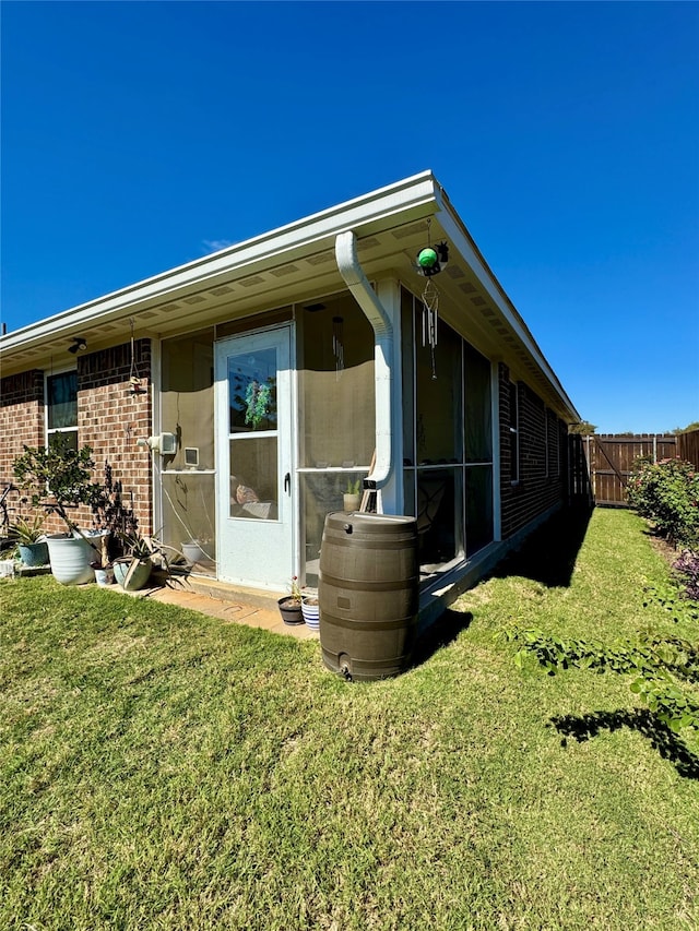 rear view of property featuring a yard