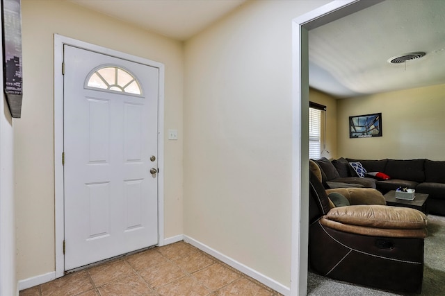 foyer entrance with light tile patterned flooring