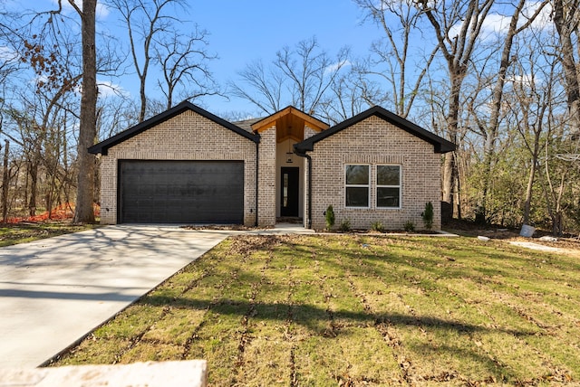 view of front of property with a garage and a front lawn