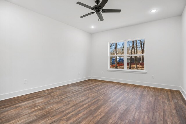 unfurnished room featuring ceiling fan and dark wood-type flooring