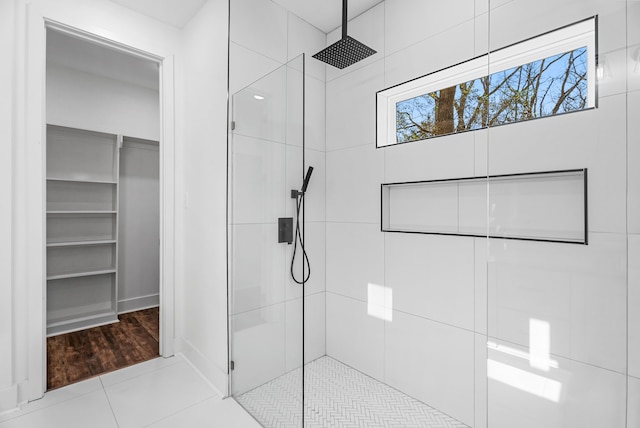 bathroom featuring a tile shower and tile patterned floors