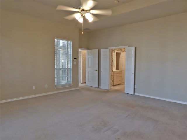 carpeted spare room featuring ceiling fan