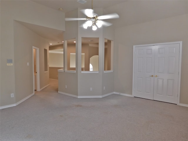 spare room featuring ceiling fan and light carpet