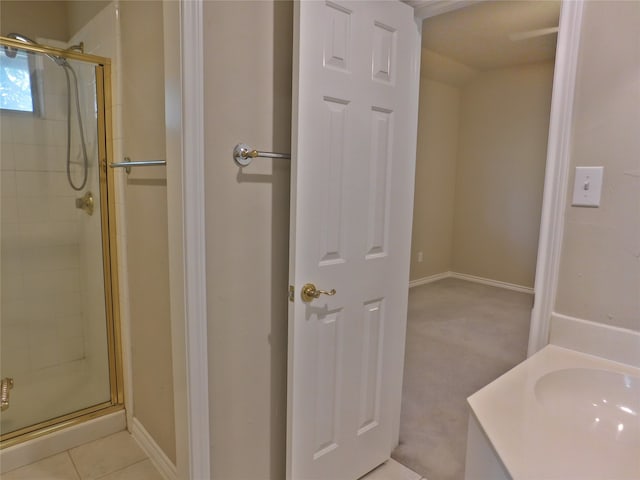 bathroom featuring vanity, tile patterned floors, and walk in shower