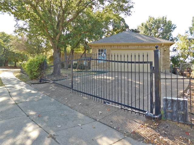 view of gate with a garage