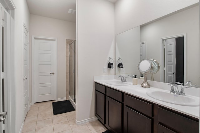 bathroom featuring vanity, tile patterned floors, and a shower with shower door