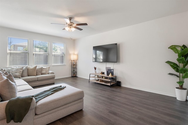 living room featuring dark wood-type flooring and ceiling fan