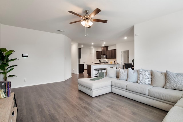 living room featuring ceiling fan and wood-type flooring