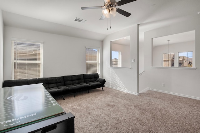 carpeted living room featuring plenty of natural light, ceiling fan, and vaulted ceiling