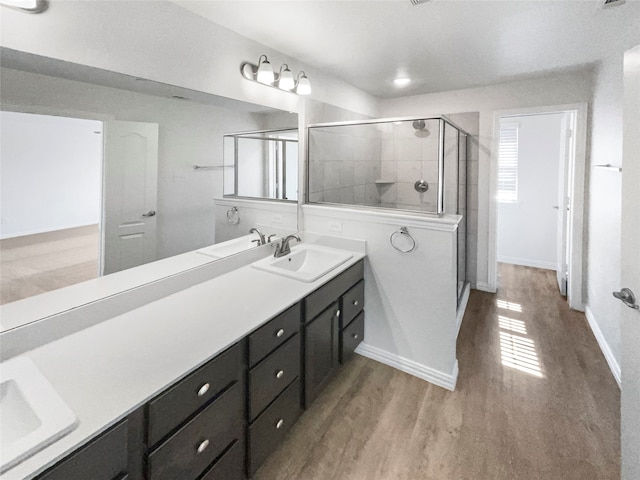 bathroom featuring vanity, a shower with shower door, and hardwood / wood-style flooring