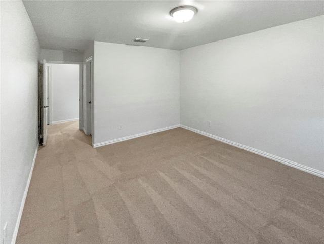 unfurnished room featuring light colored carpet