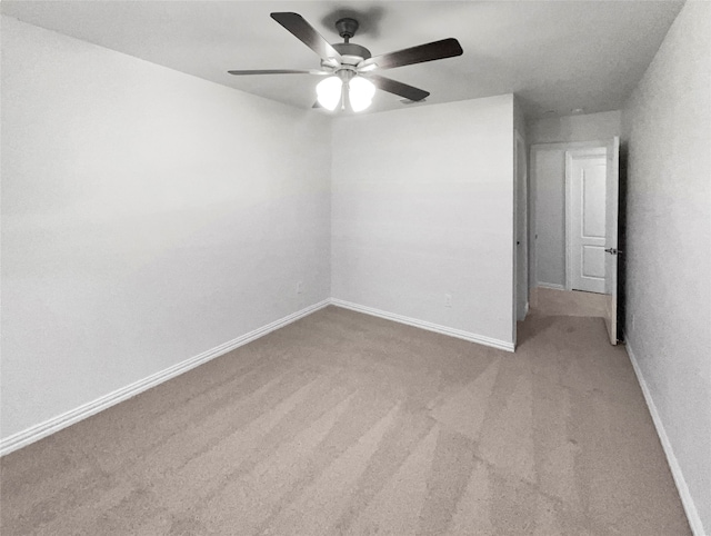 empty room featuring light colored carpet and ceiling fan