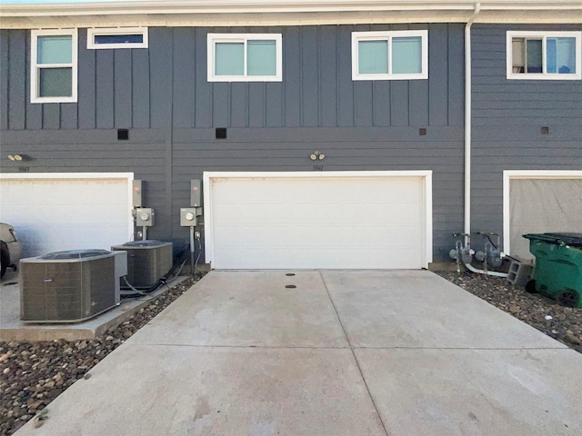 3941 Hometown Blvd, Forney, TX 75126 - exterior space featuring board and batten siding, an attached garage, driveway, and central air condition unit