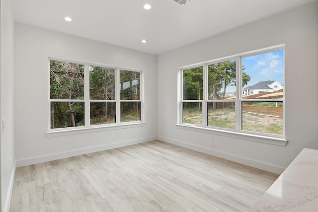 unfurnished room featuring light hardwood / wood-style flooring