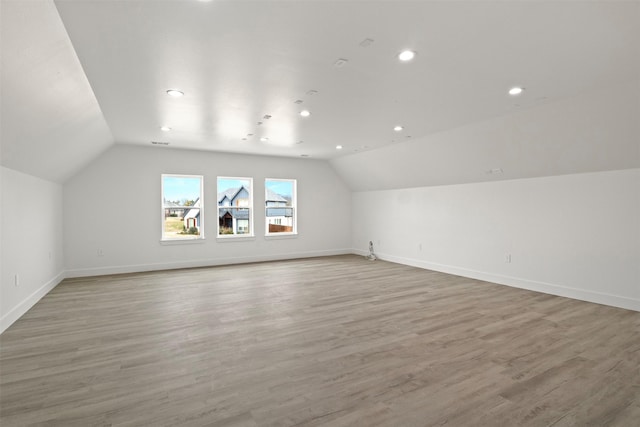 bonus room featuring light hardwood / wood-style flooring and vaulted ceiling