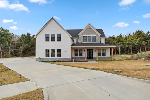 view of front of property with covered porch and a front yard