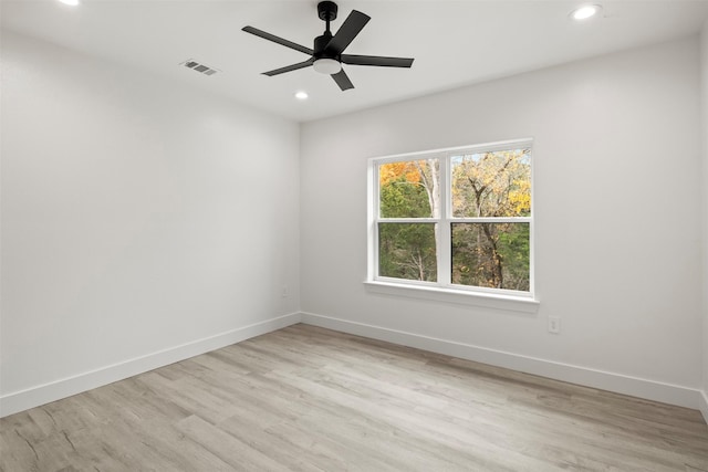 empty room with ceiling fan and light wood-type flooring