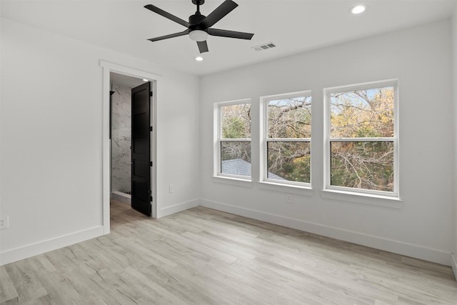 unfurnished room with light wood-type flooring and ceiling fan