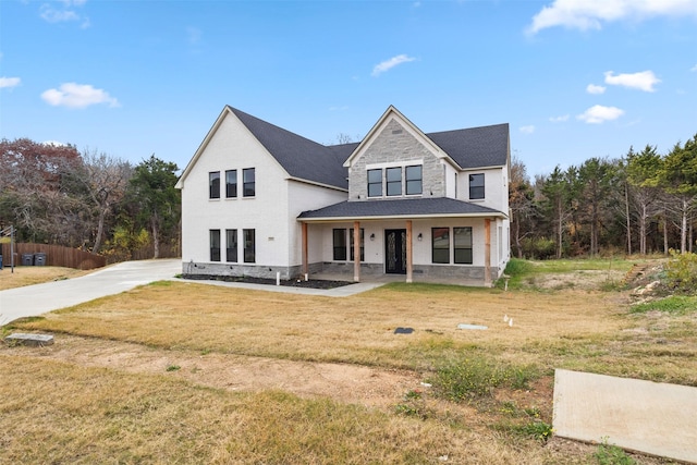 view of front of house with a front yard and covered porch