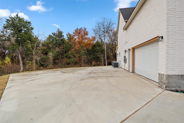 view of patio / terrace featuring a garage and central AC