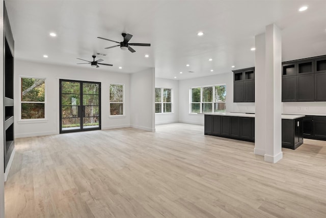 unfurnished living room with ceiling fan and light hardwood / wood-style floors