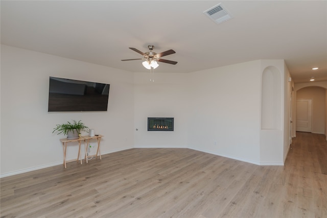 unfurnished living room with ceiling fan and light wood-type flooring