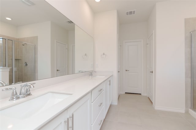 bathroom featuring tile patterned floors, vanity, and walk in shower