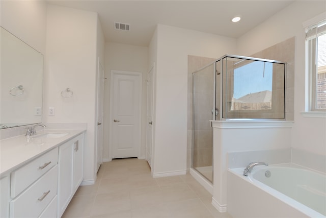 bathroom with tile patterned flooring, vanity, and separate shower and tub