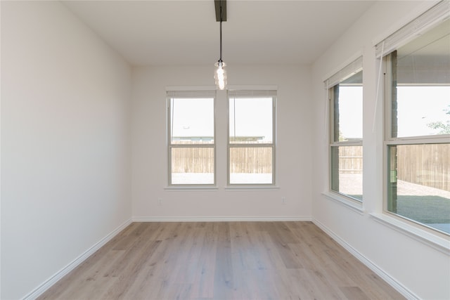 unfurnished room featuring a healthy amount of sunlight and light hardwood / wood-style floors