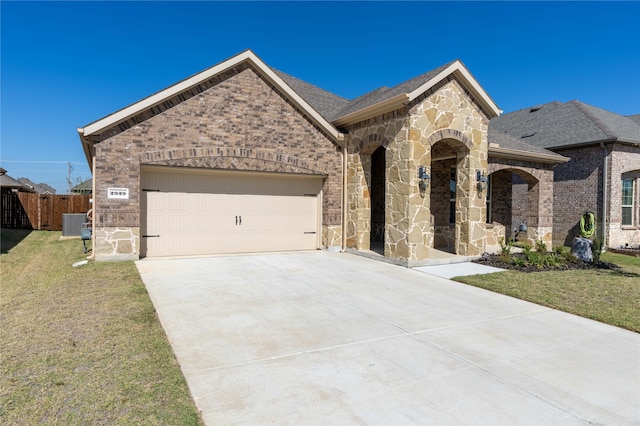 view of front of home featuring a front yard and a garage