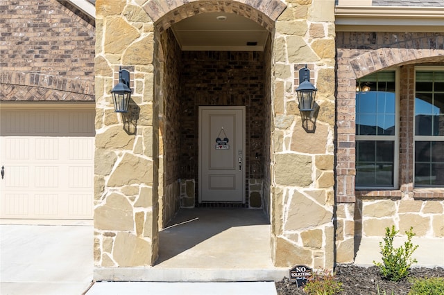 view of exterior entry featuring a garage