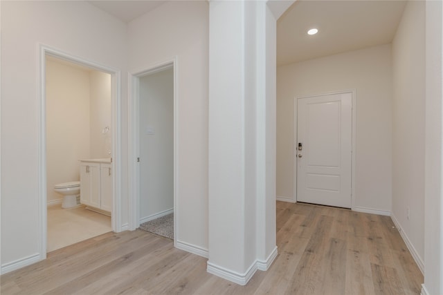 corridor with light hardwood / wood-style flooring